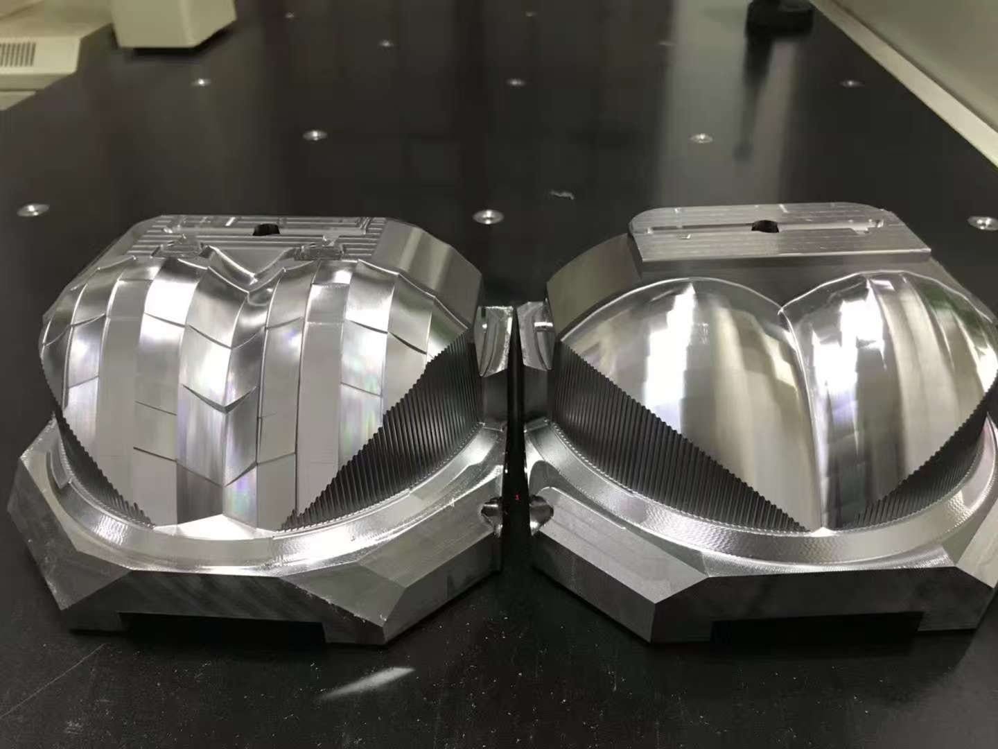 Two automotive lighting mold components with freeform and patterned surfaces